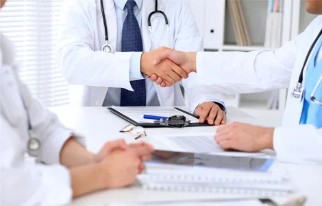 Doctors sitting at a table with paperwork