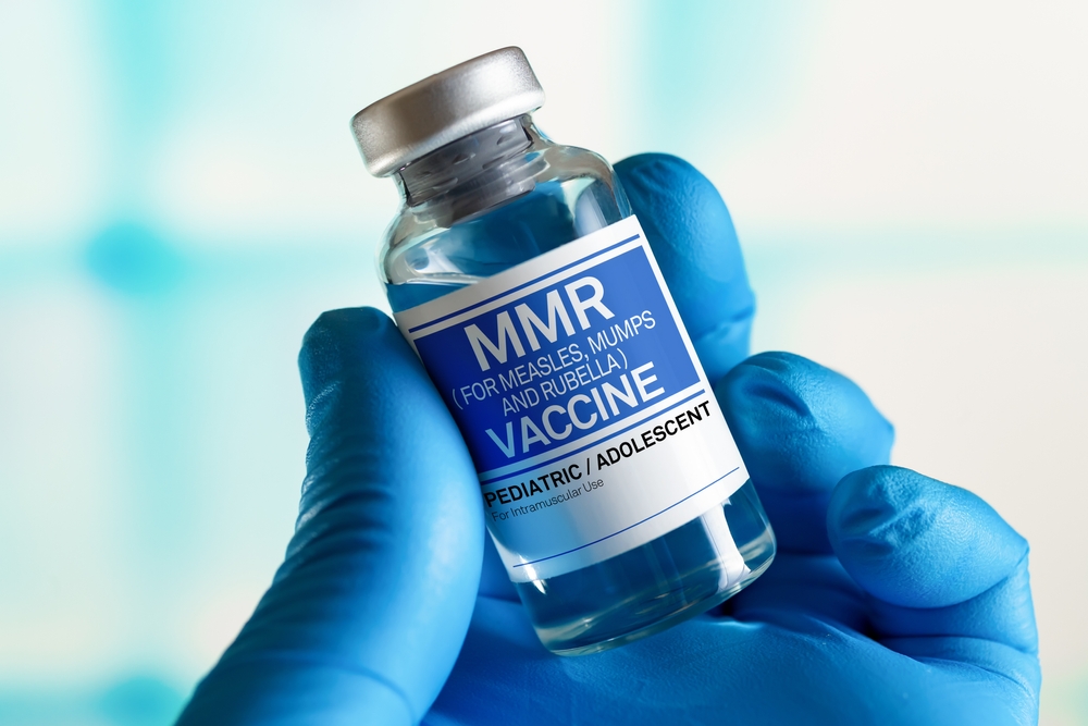 Doctor with vial of the doses vaccine for MMR Measless, Mumps and Rubella diseases