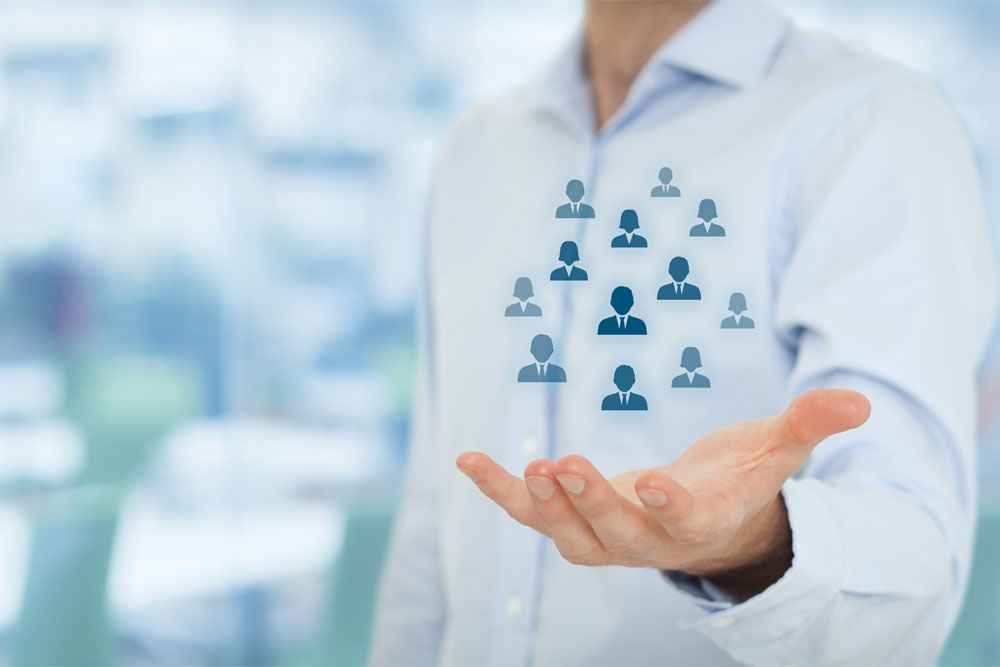 Man with hand extended with silhouette of people to show pooled resources
